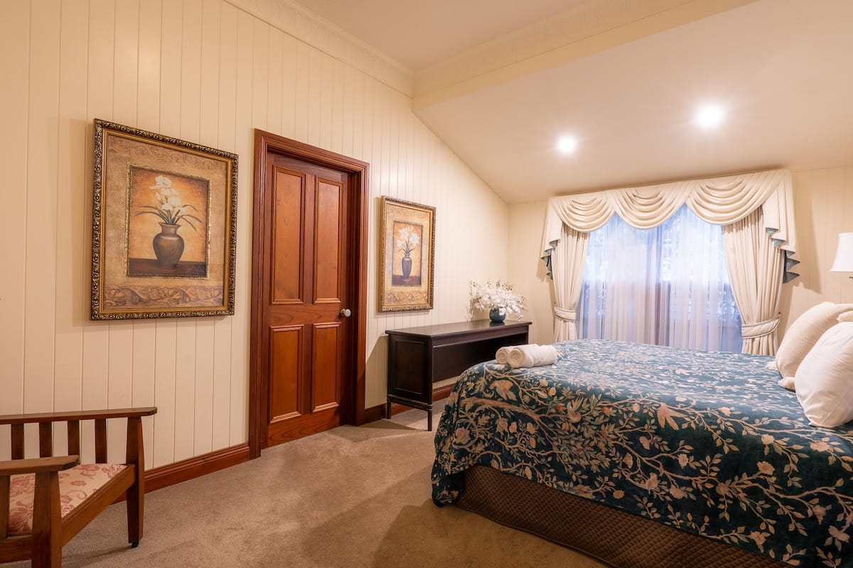 Cottage master bedroom with pitched ceiling
